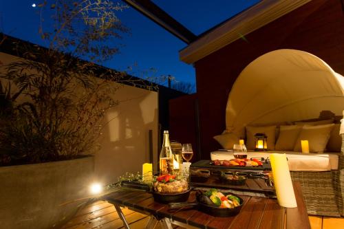 a table with food and drinks on a patio at MoonlightVilla 河口湖大橋 in Fujikawaguchiko