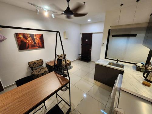 a living room with a table and a ceiling fan at Cozy Studio 3pax, Menara Sentral by VL HOME in Bukit Mertajam