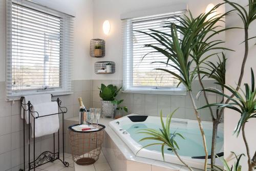 a bathroom with a bath tub with plants in it at Amaris in Daylesford