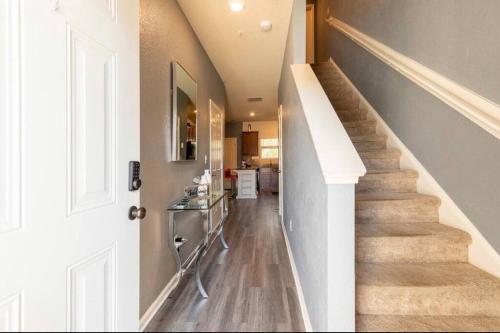 a hallway of a home with stairs and a kitchen at Modern Retreat near Hartsfield-Jackson Airport in Atlanta