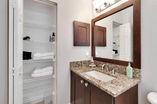 a bathroom with a sink and a mirror at Elegant Comfort - Newly Updated 3BR with Cozy Master Suite - Pet Friendly in Tarpon Springs