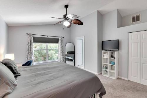 a bedroom with a bed and a ceiling fan at Elegant Comfort - Newly Updated 3BR with Cozy Master Suite - Pet Friendly in Tarpon Springs