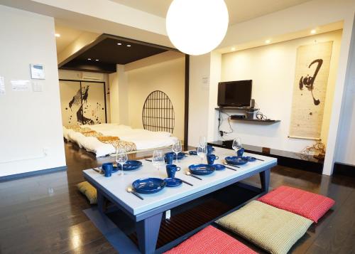 a room with a table with blue dishes on it at Stay Well & Give Well, Full Building in Asakusa in Tokyo