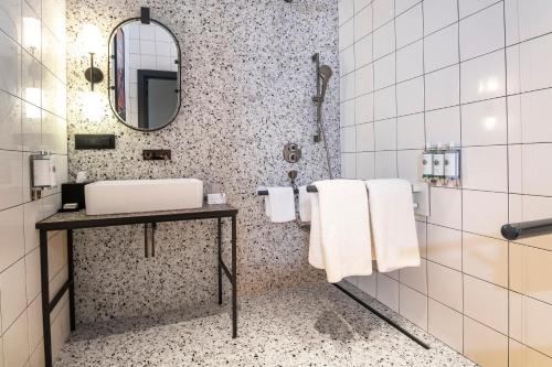 a bathroom with a sink and a mirror at Hotel Indigo Belgrade by IHG in Belgrade