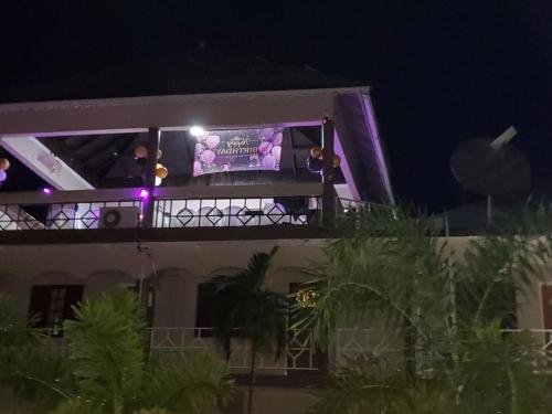 two people on the balcony of a building at night at Boutique B&B at Stone Village in Bluefields