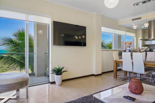 a living room with a table and a dining room at LUXURIOUS APARTMENT IN LEVENT FRONT EAGLE BEACH in Palm-Eagle Beach