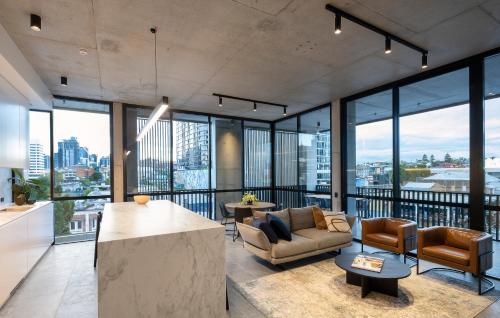 a living room with a view of a city at Alfred & Turner Apartments, Luxury 2 Bedroom Condos in the heart of the Valley in Brisbane