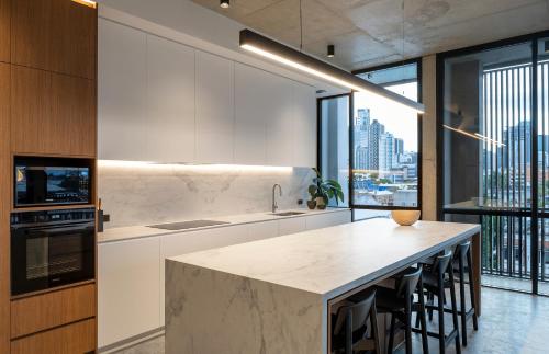 a kitchen with a large island with a counter top at Alfred & Turner Apartments, Luxury 2 Bedroom Condos in heart of the Valley in Brisbane