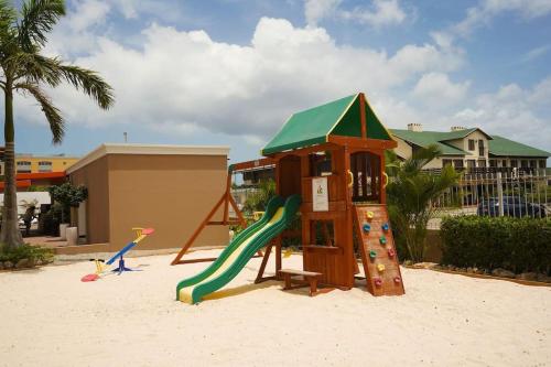 a playground with a slide in the sand at LUXURIOUS APARTMENT IN LEVENT FRONT EAGLE BEACH in Palm-Eagle Beach