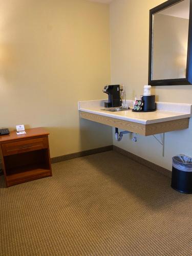 a bathroom with a sink and a mirror at Wingate by Wyndham Mount Vernon in Mount Vernon