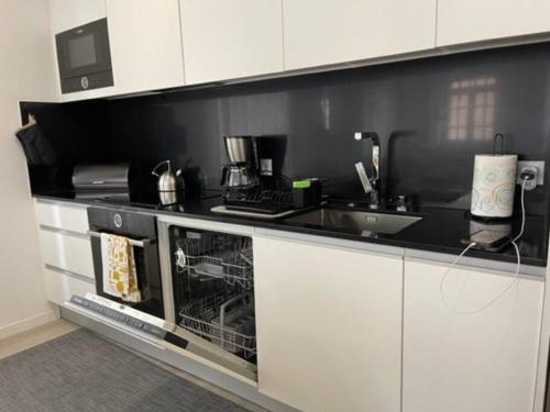 a kitchen with a sink and a counter top at Modern 1 Bedroom City Center Aveiro Apartment in Aveiro