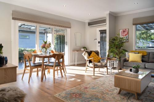 a living room with a table and chairs at Arabella Heights in Daylesford