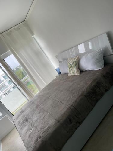 a large bed in a room with a large window at DesSea Island-Sosua Ocean Village in Sosúa