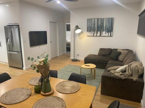 a living room with a couch and a table at Banjo's Rest in Jindabyne