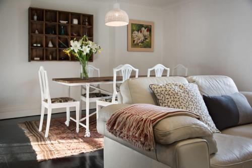 a living room with a couch and a table and chairs at Aysgarth in Daylesford