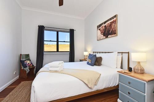 a bedroom with a large white bed and a window at The Glass Ceiling 360 degree Mount View Hideaway in Mount View