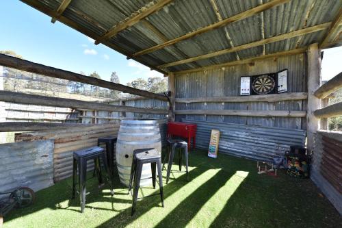 a barn with stools and a grill in it at The Glass Ceiling 360 degree Mount View Hideaway in Mount View
