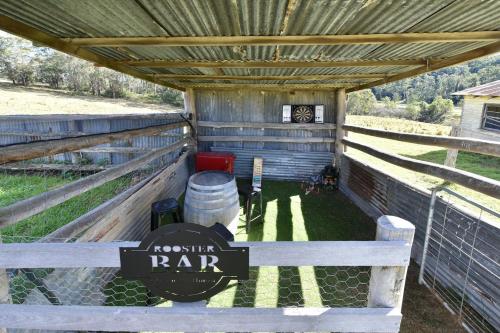 a horse pen with a sign that reads rooster rap at The Glass Ceiling 360 degree Mount View Hideaway in Mount View