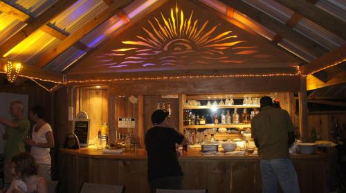 a group of people standing at a bar at Castara Retreats in Castara