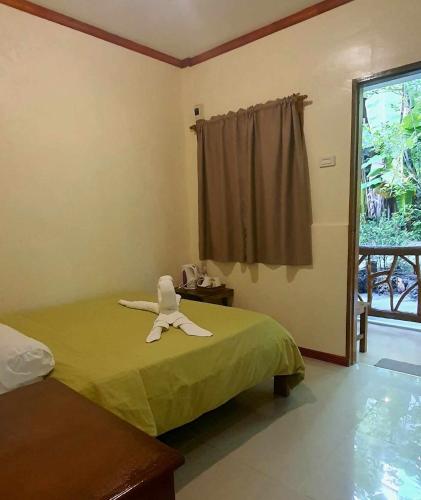 a room with a bed with a towel on it at TAGBALAYON Lodging House in Siquijor