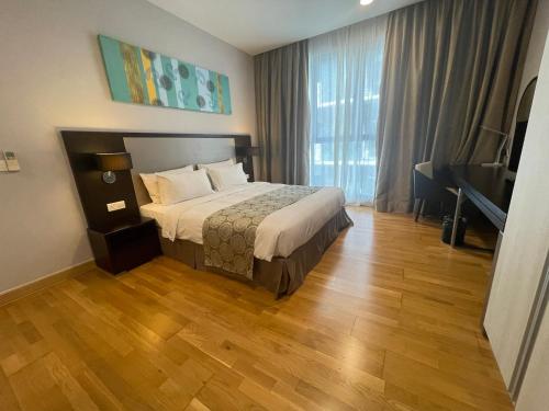 a hotel room with a bed and a piano at Trinidad Suites Johor, Trademark Collection by Wyndham in Nusajaya
