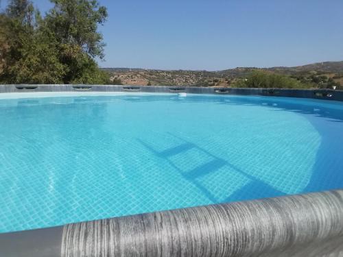 a large swimming pool with blue water at Despina country retreat in Paphos City