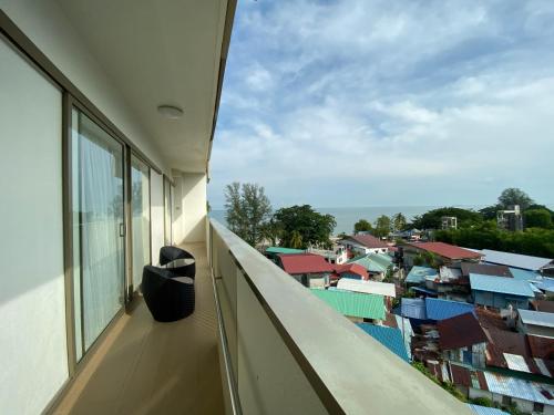 a balcony with a view of a city at By The Sea Side Seaview and Mountain View 252 in Batu Ferringhi