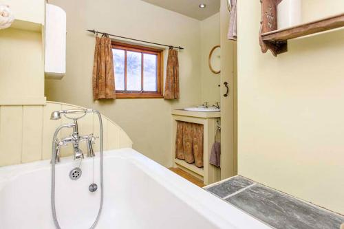 a bathroom with a tub and a shower in it at Cat's Cradle, Cottage In Beautiful and Peaceful Location, Near Beach in Sennen