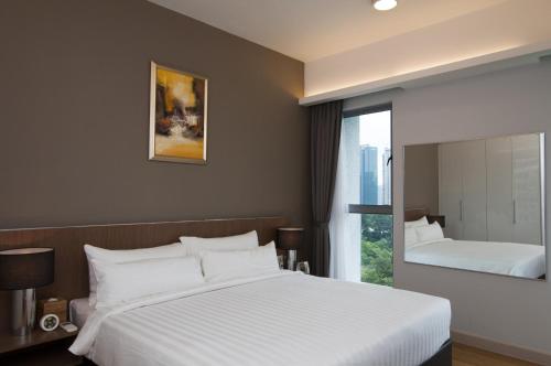 A bed or beds in a room at Suasana Suites Bukit Ceylon