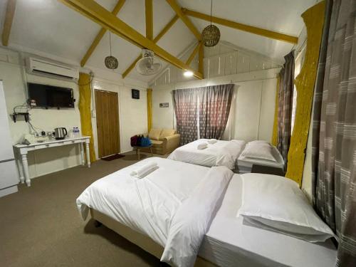 Zimmer mit 3 Betten und einem Waschbecken. in der Unterkunft TERATAK AL QARNI in Jitra