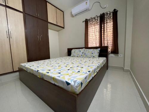a bedroom with a large bed in a room at SSN Home Stays in Tirupati Near Alipiri in Tirupati