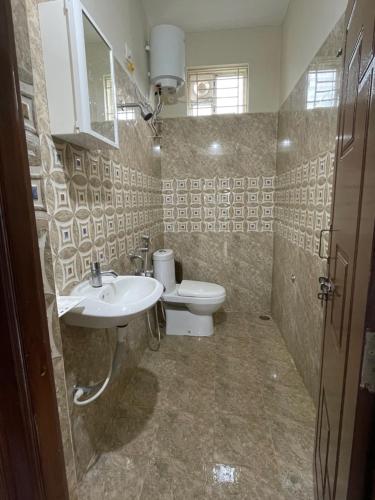 a bathroom with a toilet and a sink at SSN Home Stays in Tirupati Near Alipiri in Tirupati
