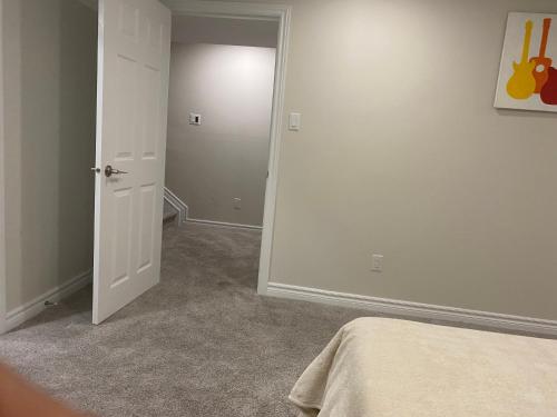 an empty room with a bed and an open door at Stay with Star in Ottawa