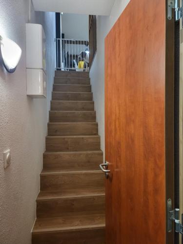 a stairway with a wooden door and a stair case at Appartements pied des pistes - Résidence Mongie - Tourmalet in La Mongie