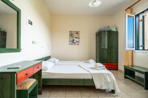 a bedroom with a bed and a sink at Anemona studio E in Katelios