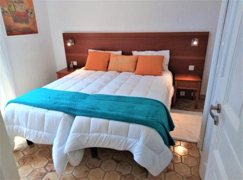 Schlafzimmer mit einem großen Bett mit einem Kopfteil aus Holz in der Unterkunft Appartement 10 en duplex - LES SUITES DE ROBINSON - Résidence avec piscine en bord de Siagne, à Mandelieu-La-Napoule in Mandelieu-la-Napoule