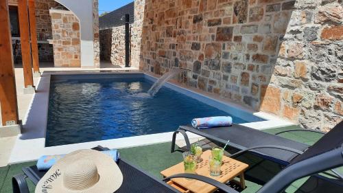 a swimming pool with a fountain in a house at Holiday Home Rakova in Gornje Selo