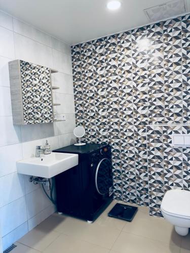 a bathroom with a sink and a toilet at Isco Apartment in Kuressaare