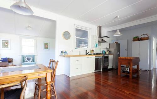 a kitchen with a dining table and a kitchen with white cabinets at Harbour View Motel in Robe