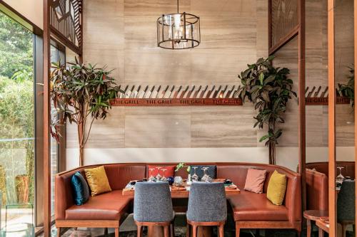a dining room with a table and chairs at Gran Melia Arusha in Arusha