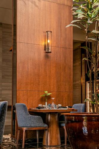 a dining room with a table and chairs at Gran Melia Arusha in Arusha