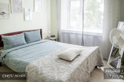 a bedroom with a bed with a pillow on it at City Center Turu str apartments, parking, Tartu Home in Tartu