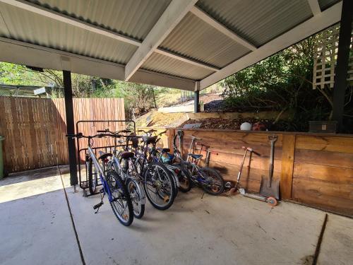 a group of bikes parked under a building at 'Wahroonga' home among the Gum trees in Warburton in Warburton