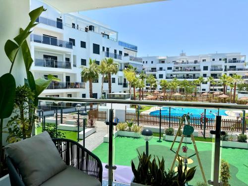 an apartment balcony with a view of a swimming pool at Aguacate Beach Apartamentos Playa Granada in Motril
