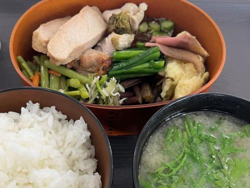 three bowls of food with rice and meat and vegetables at 松代棚田ハウス 