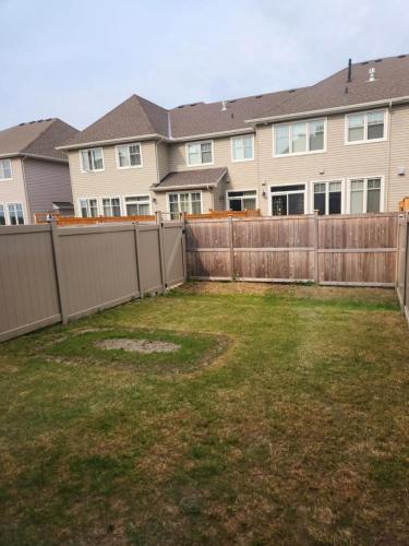 a yard with a fence and a house at Stay with Star in Ottawa