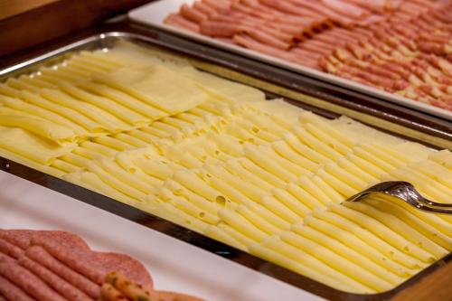 a tray of food with cheese and other meats at Hotel-Restaurant Grimmingblick in Bad Mitterndorf
