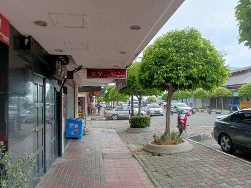 a sidewalk with trees on the side of a street at HOTEL PANTAI VIEW in Labuan