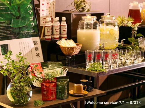 a display of drinks and glasses on a shelf at Oriental Hotel Hiroshima in Hiroshima