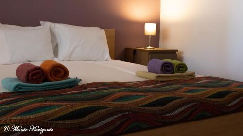 a bedroom with a bed with towels on it at Monte Horizonte - Villas Privadas - Eco e Natureza - Adults Only in Santiago do Cacém